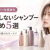 「ヘアカラーを長持ち 色落ちしないシャンプーおすすめ5選 市販＆美容師厳選のカラーケア」という見出しのアイキャッチ画像。美しいブラウンヘアの女性が振り返る隣に、5種類のカラーケア用シャンプーボトルが並んでいます。背景は上品な薄紫色のドレープで、美しい髪色を保つイメージが表現されています。